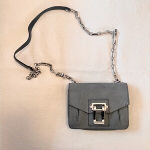 Small proenza cross body. Has a silver chain, and silver clasp